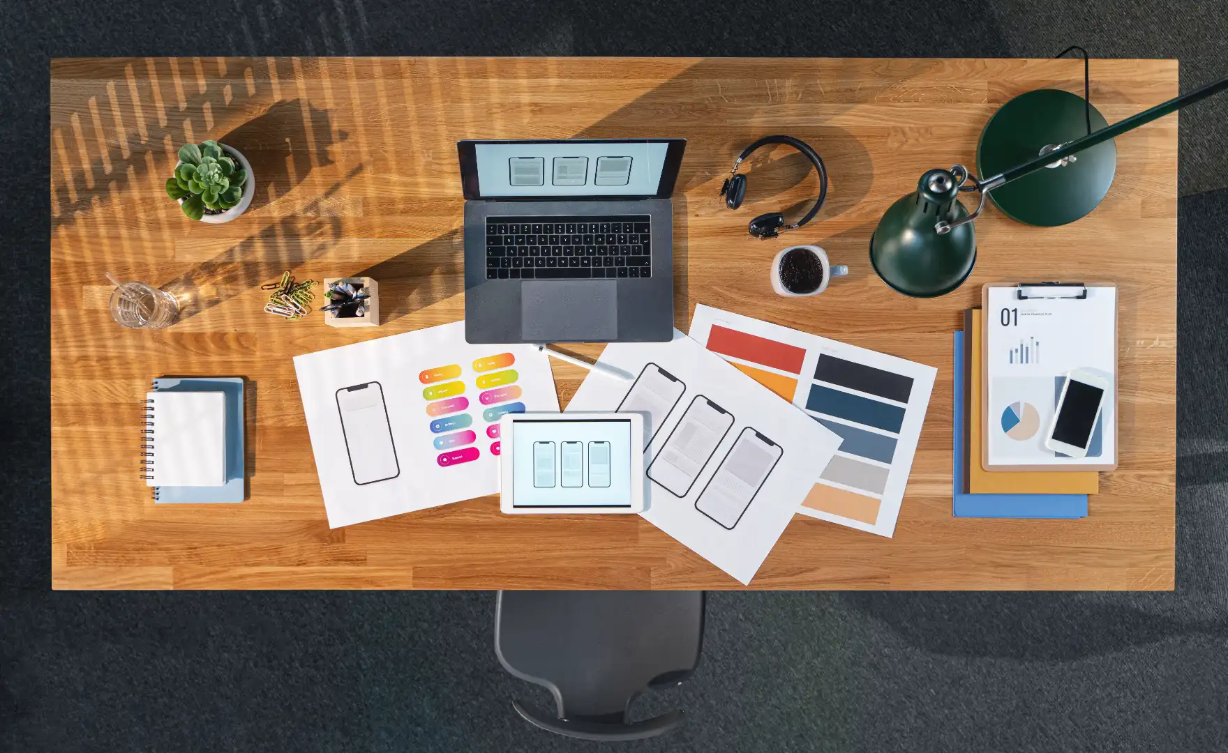 Overhead desk with campaign planning papers, tablet, and creative materials