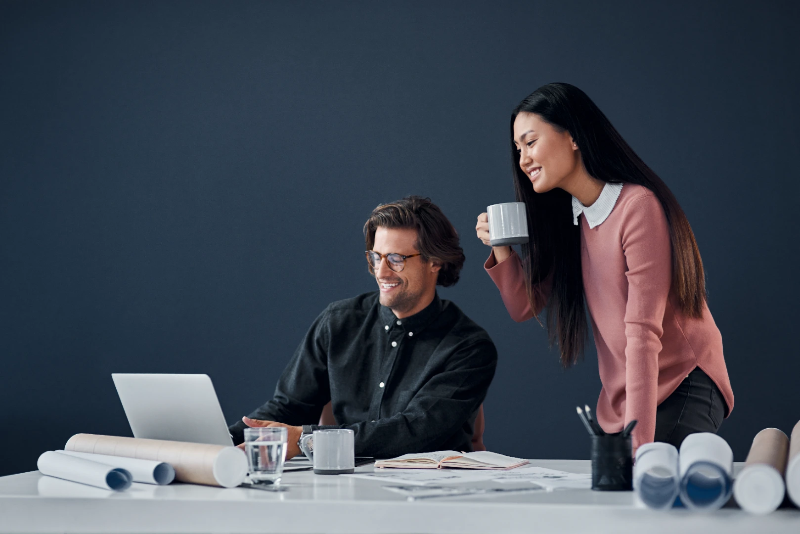 Colleagues discussing strategy at an office desk